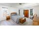 Bright main bedroom with neutral decor, large windows, and classic wooden furniture at 9901 Pallisers Ter, Charlotte, NC 28210