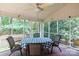 Comfortable screened-in porch, great for relaxing and enjoying the outdoors, with a table and chairs at 9901 Pallisers Ter, Charlotte, NC 28210
