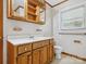 Bathroom featuring a wood vanity and medicine cabinet with tiled walls at 1008 Midway Dr, Gastonia, NC 28054