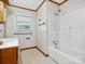 Classic bathroom with a tiled shower-tub combination and vanity with window at 1008 Midway Dr, Gastonia, NC 28054
