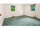 Carpeted bedroom with two windows offering natural light and outdoor views at 1008 Midway Dr, Gastonia, NC 28054