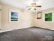 Neutral bedroom with carpet, ceiling fan, and two windows for ample light at 1008 Midway Dr, Gastonia, NC 28054