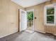 Cozy foyer with patterned carpet and an open doorway leading to the exterior deck at 1008 Midway Dr, Gastonia, NC 28054