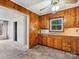 Functional kitchen showcasing knotty wood cabinets and durable tile flooring at 1008 Midway Dr, Gastonia, NC 28054