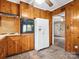 View of kitchen with knotty wood cabinets, modern appliances and doorway leading to front of house at 1008 Midway Dr, Gastonia, NC 28054