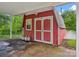Red shed exterior with double doors and small window near a carport area at 1008 Midway Dr, Gastonia, NC 28054