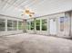 Bright sunroom featuring lots of windows for natural light and neutral carpeting at 1008 Midway Dr, Gastonia, NC 28054