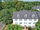 Aerial view of the condo features lush green trees surrounding the building and a partial lake view at 1023 Triece Ln, Charlotte, NC 28215