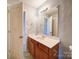 Bathroom featuring a large mirror and vanity with light wood cabinets, ready for updates at 1023 Triece Ln, Charlotte, NC 28215