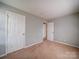 Empty bedroom showcases neutral walls, carpet, and natural light at 1023 Triece Ln, Charlotte, NC 28215