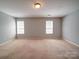 Spacious bedroom with two windows, allowing plenty of natural light to fill the space at 1023 Triece Ln, Charlotte, NC 28215