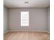 Simple bedroom with carpet and a large window providing ample natural light at 1023 Triece Ln, Charlotte, NC 28215