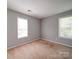 Carpeted bedroom featuring natural light from two windows, offering a comfortable space at 1023 Triece Ln, Charlotte, NC 28215