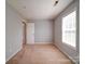 Neutral bedroom with a large window and carpeted floor, ready for personalization at 1023 Triece Ln, Charlotte, NC 28215