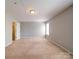Expansive bedroom featuring neutral walls, carpet, and natural light from a single window at 1023 Triece Ln, Charlotte, NC 28215