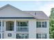 Close view of a building featuring white siding, a balcony, and windows with dark blue shutters at 1023 Triece Ln, Charlotte, NC 28215