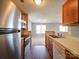 Efficient kitchen with stainless steel appliances and laminate countertops open to the main living space at 1023 Triece Ln, Charlotte, NC 28215