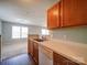 Kitchen sink and countertop area, with light wood cabinets and adjacent living space at 1023 Triece Ln, Charlotte, NC 28215
