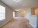 Inviting living room with a ceiling fan, bright window, patio access and neutral carpet at 1023 Triece Ln, Charlotte, NC 28215