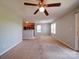 Bright living room with neutral walls, carpet and a view of the kitchen and patio access at 1023 Triece Ln, Charlotte, NC 28215