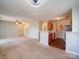 Open-concept living area showcasing neutral carpet, and seamless flow into kitchen at 1023 Triece Ln, Charlotte, NC 28215