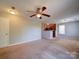 Comfortable living room with ceiling fan and an open view of the adjacent kitchen at 1023 Triece Ln, Charlotte, NC 28215