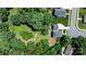 An aerial view shows the property boundaries, house, driveway, and surrounding lush greenery at 1067 33Rd Avenue Ne Loop, Hickory, NC 28601