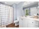 Bright bathroom with a white vanity, toilet, and shower with patterned shower curtain at 1067 33Rd Avenue Ne Loop, Hickory, NC 28601