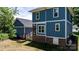View of the backyard with a blue home featuring a brick foundation, wooden deck and screened-in porch at 1067 33Rd Avenue Ne Loop, Hickory, NC 28601