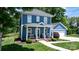 Charming two-story blue home with a covered front porch, landscaped yard, and detached garage at 1067 33Rd Avenue Ne Loop, Hickory, NC 28601