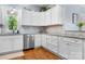 Well-lit kitchen with white cabinets, stainless steel appliances, and hardwood floors for a clean, modern look at 1067 33Rd Avenue Ne Loop, Hickory, NC 28601