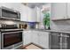Well-lit kitchen featuring white cabinets, modern stainless steel appliances, and a window with natural light at 1067 33Rd Avenue Ne Loop, Hickory, NC 28601