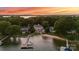 Aerial view of a waterfront estate with a dock, sandy beach, and lush landscaping at 123 Sailview Rd, Mooresville, NC 28117