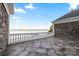 Outdoor balcony with stone exterior, white railing and tranquil views of the water and horizon at 123 Sailview Rd, Mooresville, NC 28117