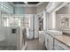 Bathroom featuring double vanities, large mirrors, and a glass enclosed shower at 123 Sailview Rd, Mooresville, NC 28117