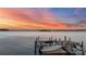Picturesque waterfront view of a private dock with a boat under a vibrant sunset sky at 123 Sailview Rd, Mooresville, NC 28117