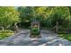 Gated community entrance with stone pillars, manicured landscaping, and a secure entry system at 123 Sailview Rd, Mooresville, NC 28117