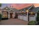 Stunning stone home with a brick driveway, a 4-car garage, and a beautiful sunset backdrop at 123 Sailview Rd, Mooresville, NC 28117