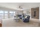A spacious living room with a sectional sofa and floor-to-ceiling windows providing breathtaking water views at 123 Sailview Rd, Mooresville, NC 28117