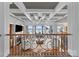 Elegant living room boasts coffered ceilings and stunning lake views from expansive windows at 123 Sailview Rd, Mooresville, NC 28117