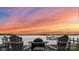 Enjoy stunning sunset views from the backyard firepit overlooking the calm lake and private dock at 123 Sailview Rd, Mooresville, NC 28117