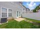 The backyard has a small patio and a white fence surrounding a green lawn at 12350 Swan Wings Pl, Huntersville, NC 28078