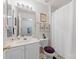 Bathroom featuring white vanity, toilet with purple seat cover, and framed art at 12350 Swan Wings Pl, Huntersville, NC 28078