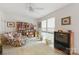 Bedroom with white walls, carpet, a floral armchair, bookshelves, and a television at 12350 Swan Wings Pl, Huntersville, NC 28078
