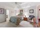 Cozy bedroom featuring a bed with patterned bedding, soft carpet, and a ceiling fan at 12350 Swan Wings Pl, Huntersville, NC 28078