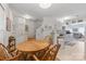 Cozy dining area with round wooden table and chairs, located adjacent to staircase and open kitchen at 12350 Swan Wings Pl, Huntersville, NC 28078