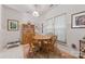 Bright dining area featuring a round wooden table with four chairs and sunny views from the adjacent windows at 12350 Swan Wings Pl, Huntersville, NC 28078