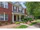 Charming townhouse with brick and siding, complemented by well-maintained landscaping and a inviting front porch at 12350 Swan Wings Pl, Huntersville, NC 28078