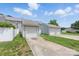 A single car garage with white siding sits at the end of a concrete driveway and green lawn at 12350 Swan Wings Pl, Huntersville, NC 28078