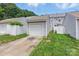 A single car garage with white siding sits at the end of a concrete driveway and green lawn at 12350 Swan Wings Pl, Huntersville, NC 28078
